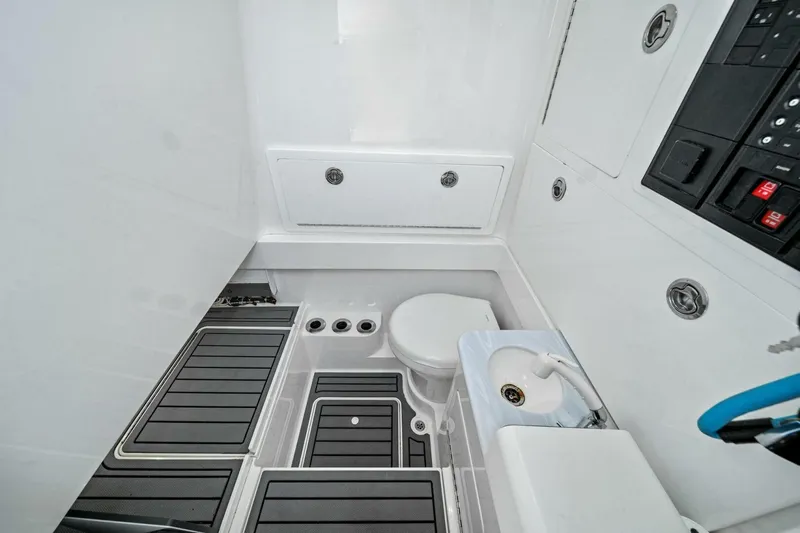 Lily Yacht Photos Pics 2021 Valhalla Boatworks V-33 interior with compact bathroom and modern amenities.