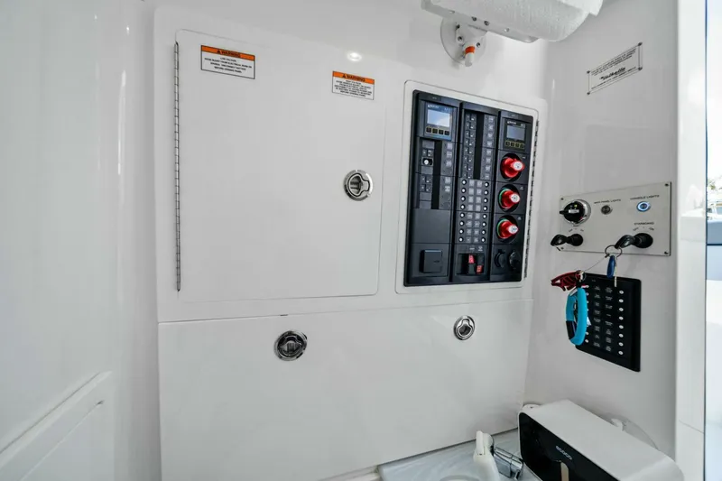 Lily Yacht Photos Pics Electrical panel inside 2021 Valhalla Boatworks V-33, featuring control switches and safety instructions.