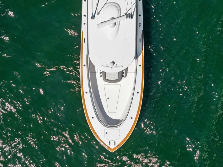 Lily Yacht Photos Pics 2021 Valhalla Boatworks V-33, aerial view, cruising on clear green water.