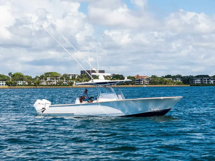 Lily Yacht Photos Pics 2021 Valhalla Boatworks V-33 cruising on a sunny day, with fishing rods visible.