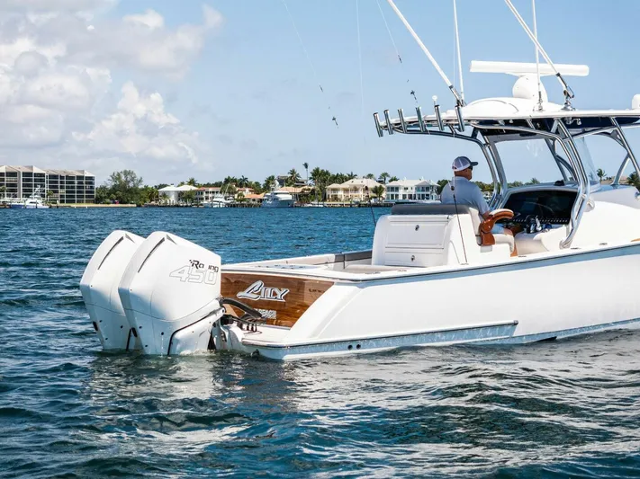 Lily Yacht Photos Pics 2021 Valhalla Boatworks V-33 cruising on a sunny day near coastal homes.