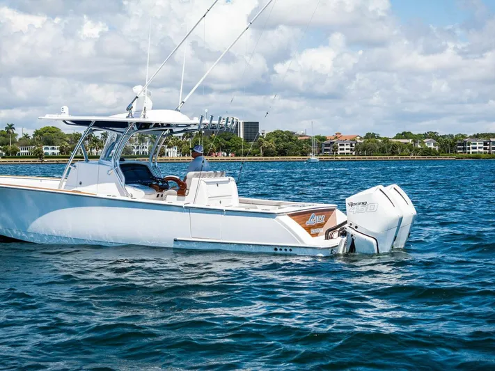 Lily Yacht Photos Pics 2021 Valhalla Boatworks V-33 cruising on a sunny day, showcasing sleek design and powerful engines.