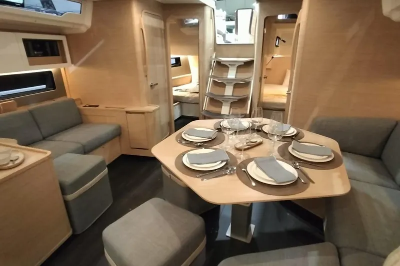  Yacht Photos Pics Luxurious interior of 2024 Dufour 44 yacht with elegant dining setup.