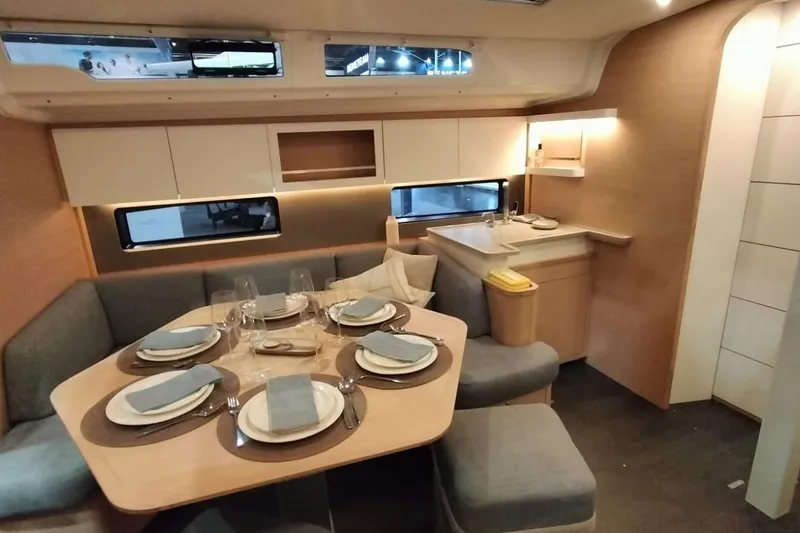  Yacht Photos Pics Luxurious interior of 2024 Dufour 44 yacht with elegant dining setup and modern furnishings.