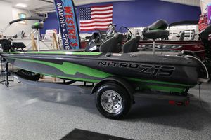 2025 Nitro Z19 boat with green accents displayed indoors at a marine sports store.