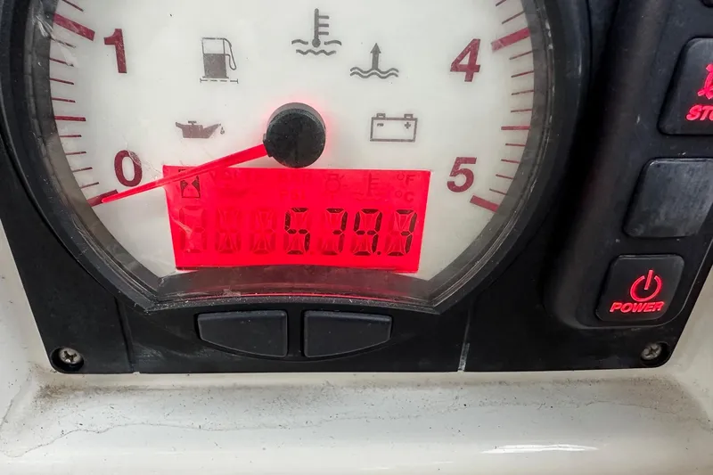 Pain Killer Yacht Photos Pics Close-up of Bavaria C50 2020 boat gauge displaying 570.8 hours with power button.