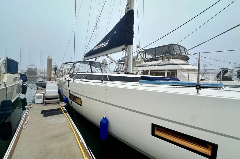 Pain Killer Yacht Photos Pics 2020 Bavaria C50 yacht docked in a foggy marina, showcasing sleek design and modern features.