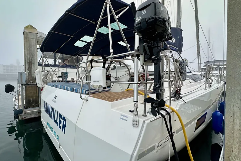 Pain Killer Yacht Photos Pics 2020 Bavaria C50 yacht docked, featuring a sleek design and outboard motor.