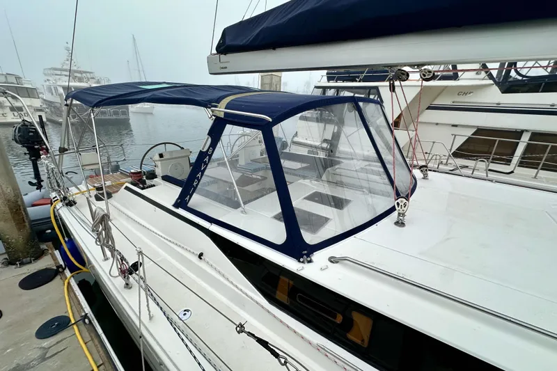 Pain Killer Yacht Photos Pics 2020 Bavaria C50 yacht docked, featuring a blue canopy and sleek design.