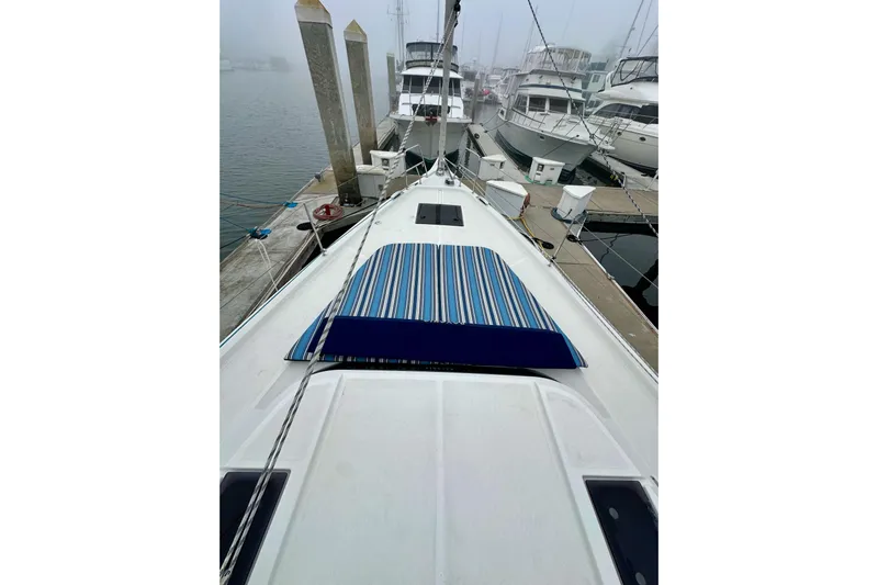 Pain Killer Yacht Photos Pics 2020 Bavaria C50 yacht docked at marina with striped deck cover.