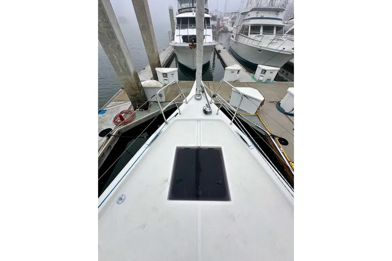 Pain Killer Yacht Photos Pics 2020 Bavaria C50 yacht docked at marina, foggy background, view from bow.