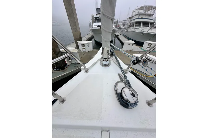 Pain Killer Yacht Photos Pics Bow of 2020 Bavaria C50 yacht docked at marina, featuring anchor chain and winch.