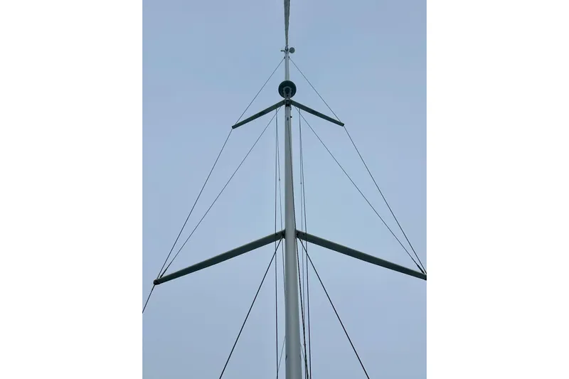 Pain Killer Yacht Photos Pics Mast of 2020 Bavaria C50 sailboat against clear sky.