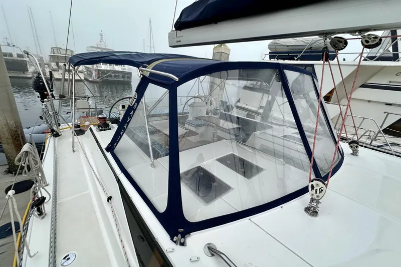 Pain Killer Yacht Photos Pics 2020 Bavaria C50 yacht with blue canopy docked at marina, featuring sleek design and modern amenities.