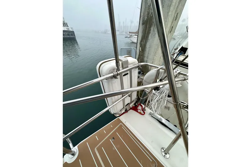 Pain Killer Yacht Photos Pics Sailboat deck view with railing and equipment, Bavaria C50, 2020 model, in a foggy marina.