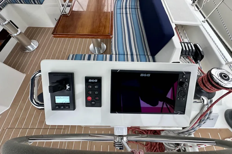 Pain Killer Yacht Photos Pics Control panel on 2020 Bavaria C50 yacht with navigation and seating area.