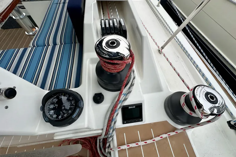 Pain Killer Yacht Photos Pics Cockpit of 2020 Bavaria C50 yacht with winches, compass, and striped seating.