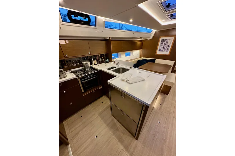Pain Killer Yacht Photos Pics Luxurious 2020 Bavaria C50 yacht interior with modern kitchen and dining area.