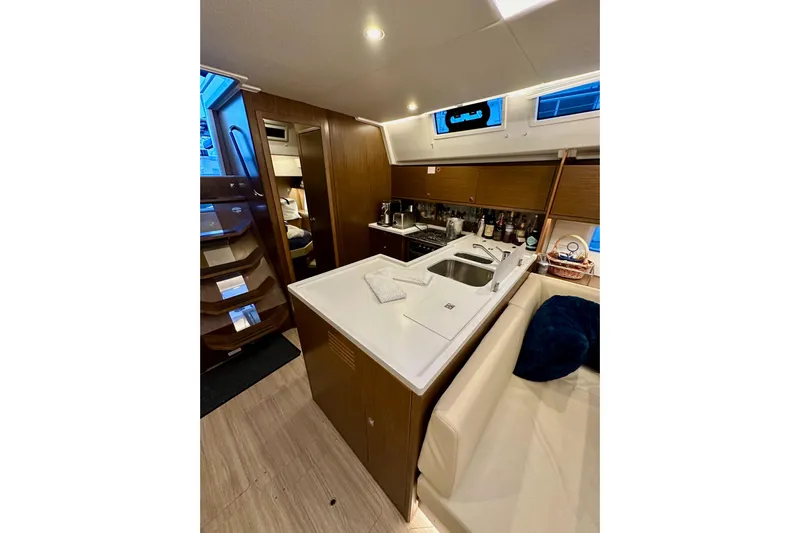 Pain Killer Yacht Photos Pics Luxurious interior of 2020 Bavaria C50 yacht featuring modern kitchen and cozy seating area.