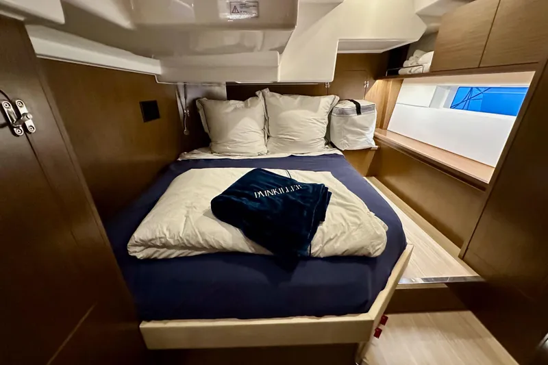Pain Killer Yacht Photos Pics Luxurious cabin interior of 2020 Bavaria C50 yacht with cozy bedding and modern design.