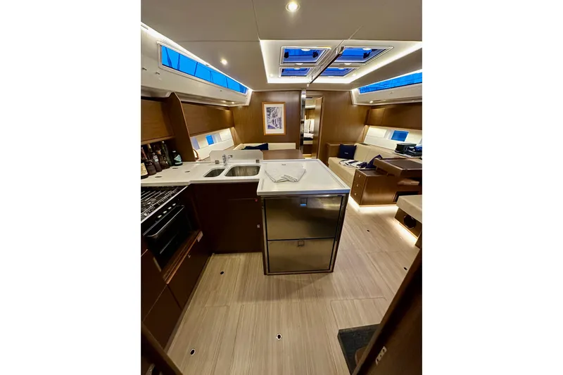 Pain Killer Yacht Photos Pics Luxurious interior of a 2020 Bavaria C50 yacht with modern kitchen and seating area.