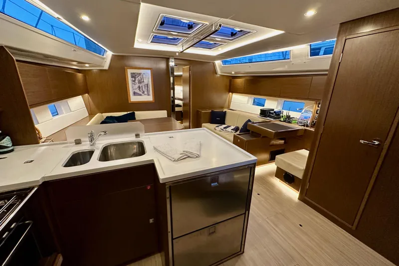 Pain Killer Yacht Photos Pics Luxurious interior of 2020 Bavaria C50 yacht with modern kitchen and seating area.