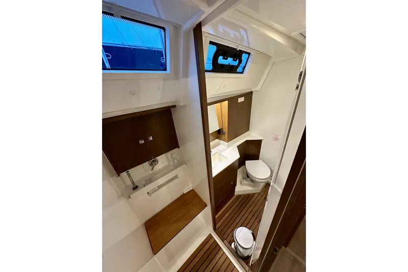 Pain Killer Yacht Photos Pics Modern bathroom interior of 2020 Bavaria C50 yacht with wooden accents and compact design.