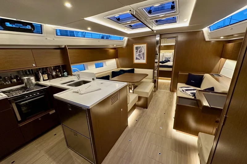 Pain Killer Yacht Photos Pics Luxurious interior of 2020 Bavaria C50 yacht with modern kitchen and seating area.
