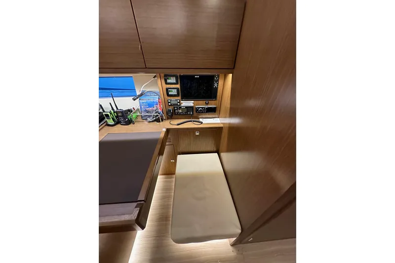 Pain Killer Yacht Photos Pics 2020 Bavaria C50 yacht interior with navigation station and wooden cabinetry.