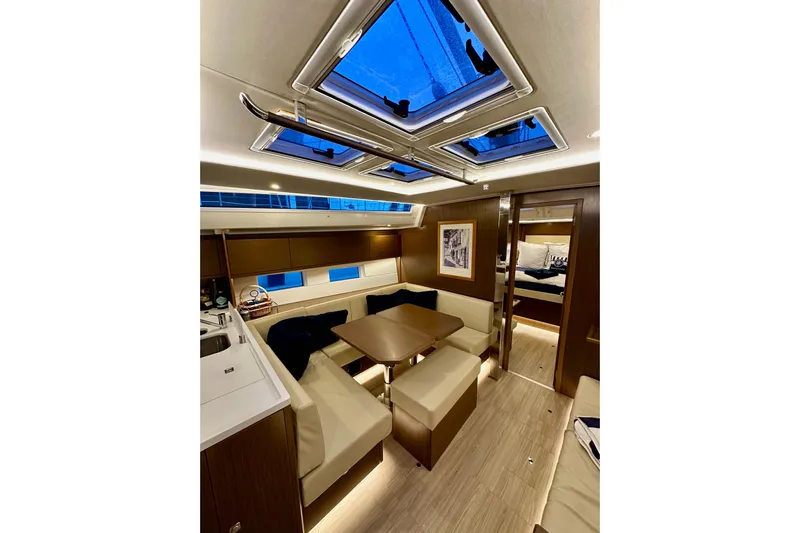 Pain Killer Yacht Photos Pics Luxurious interior of 2020 Bavaria C50 yacht with modern seating and skylights.