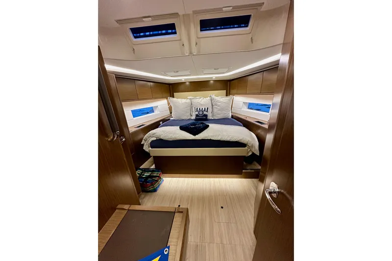 Pain Killer Yacht Photos Pics Luxurious interior cabin of 2020 Bavaria C50 yacht with cozy bedding and modern design.