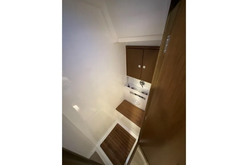 Pain Killer Yacht Photos Pics 2020 Bavaria C50 yacht bathroom with wooden accents and modern fixtures.