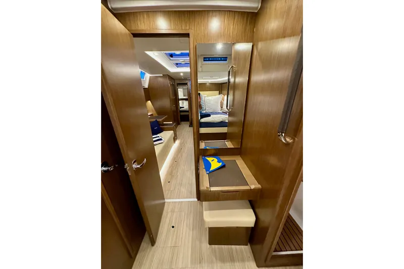 Pain Killer Yacht Photos Pics Interior of 2020 Bavaria C50 yacht, featuring wooden finishes and cozy cabin space.