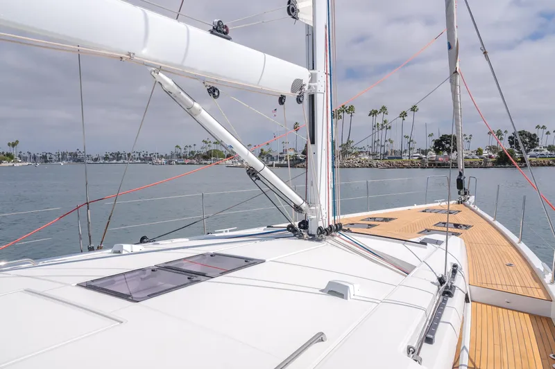 Joy Yacht Photos Pics 2023 Beneteau Oceanis Yacht 60 sailing on calm waters with clear skies.