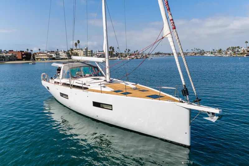 Joy Yacht Photos Pics 2023 Beneteau Oceanis Yacht 60 sailing in a serene marina setting.