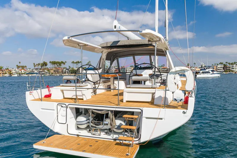 Joy Yacht Photos Pics 2023 Beneteau Oceanis Yacht 60, elegant design, docked in a sunny marina.