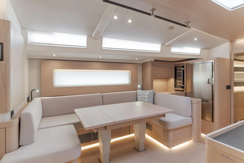 Joy Yacht Photos Pics Luxurious interior of 2023 Beneteau Oceanis Yacht 60 with modern dining area.