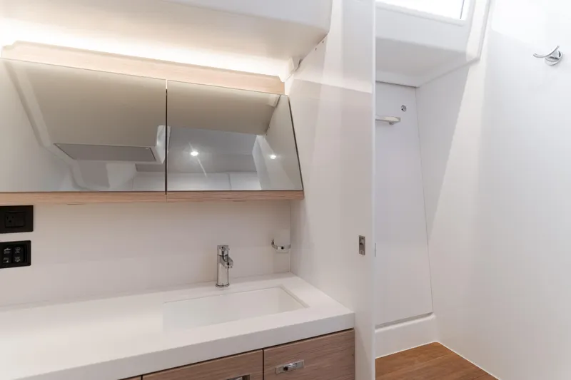 Joy Yacht Photos Pics Modern bathroom interior of 2023 Beneteau Oceanis Yacht 60, featuring sleek design and fixtures.