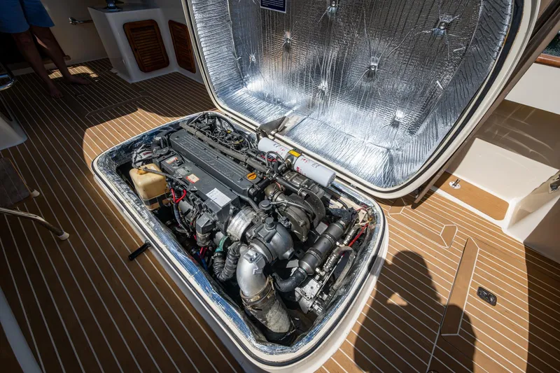 Summer Bliss Yacht Photos Pics Engine compartment of a 2001 Hinckley Picnic Boat Classic, showcasing detailed mechanical components.