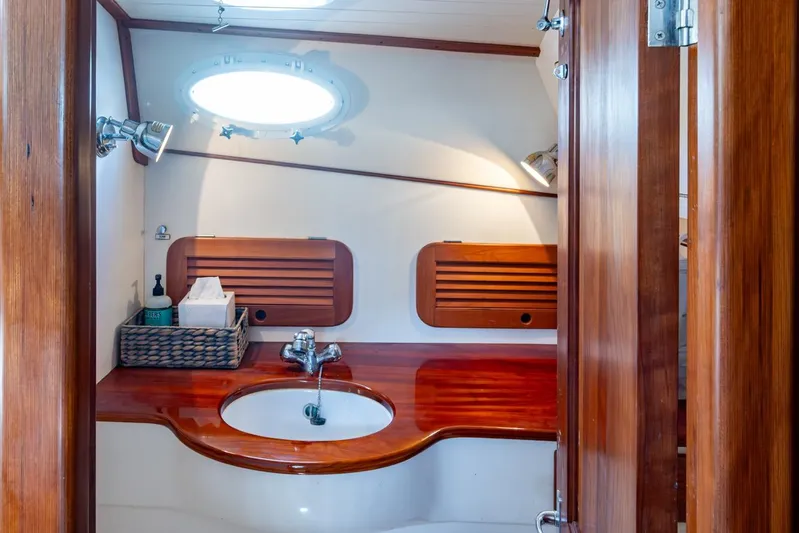 Summer Bliss Yacht Photos Pics 2001 Hinckley Picnic Boat Classic bathroom with wooden cabinetry and modern fixtures.