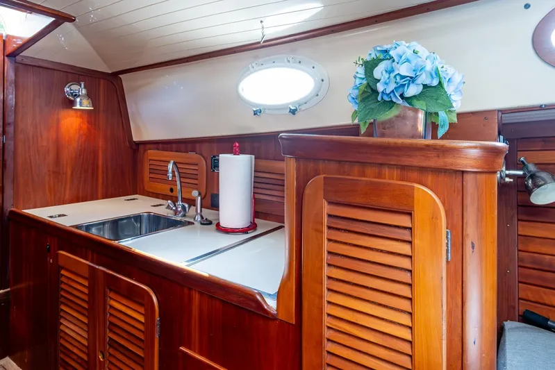 Summer Bliss Yacht Photos Pics 2001 Hinckley Picnic Boat Classic interior with wooden cabinetry and sink.