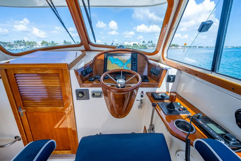 Summer Bliss Yacht Photos Pics 2001 Hinckley Picnic Boat Classic helm with wooden steering wheel and navigation system.