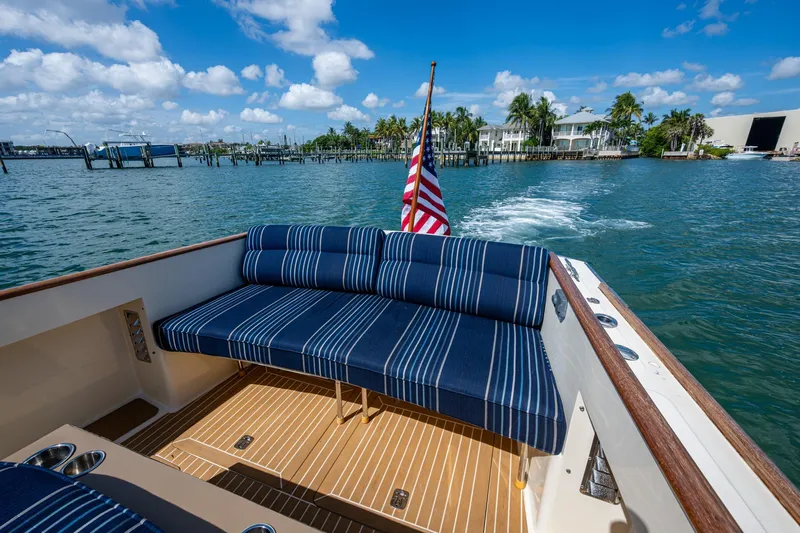 Summer Bliss Yacht Photos Pics 2001 Hinckley Picnic Boat Classic with striped seating, cruising on a sunny day.