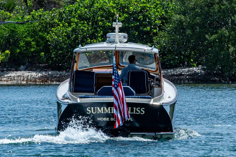 Summer Bliss Yacht Photos Pics 2001 Hinckley Picnic Boat Classic cruising on water with American flag.