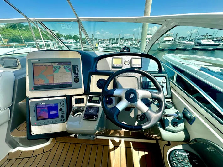 Cinta Yacht Photos Pics Helm of 2007 Cruisers Yachts 420 Express with navigation screens and controls.