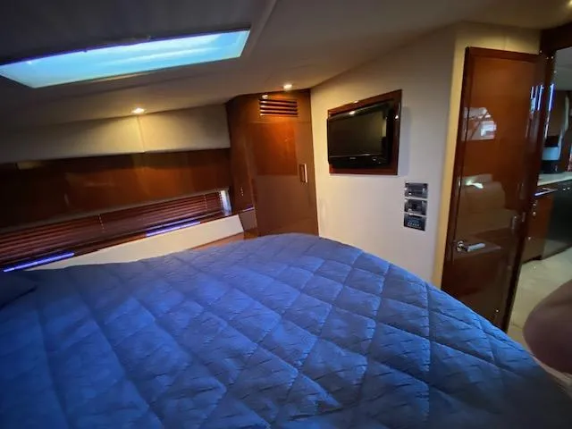 Day Dreamer Yacht Photos Pics Luxurious cabin interior of 2010 Sea Ray 450 Sundancer yacht with cozy bedding and TV.