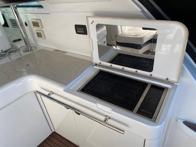 Day Dreamer Yacht Photos Pics Outdoor kitchen area on a 2010 Sea Ray 450 Sundancer yacht with grill and countertop.