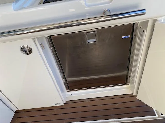 Day Dreamer Yacht Photos Pics Stainless steel fridge on 2010 Sea Ray 450 Sundancer yacht with teak flooring.