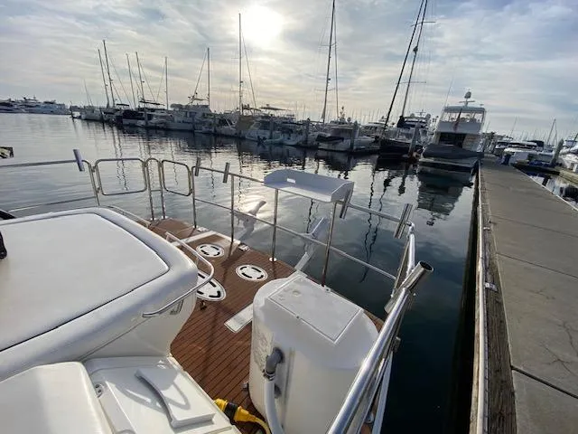 Day Dreamer Yacht Photos Pics Sea Ray 450 Sundancer 2010 docked at marina with sailboats in background.