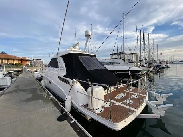 Day Dreamer Yacht Photos Pics 2010 Sea Ray 450 Sundancer yacht docked at marina under cloudy sky.